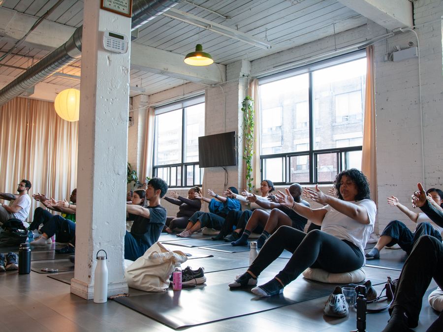 Guests at a Well Compensated breathwork session